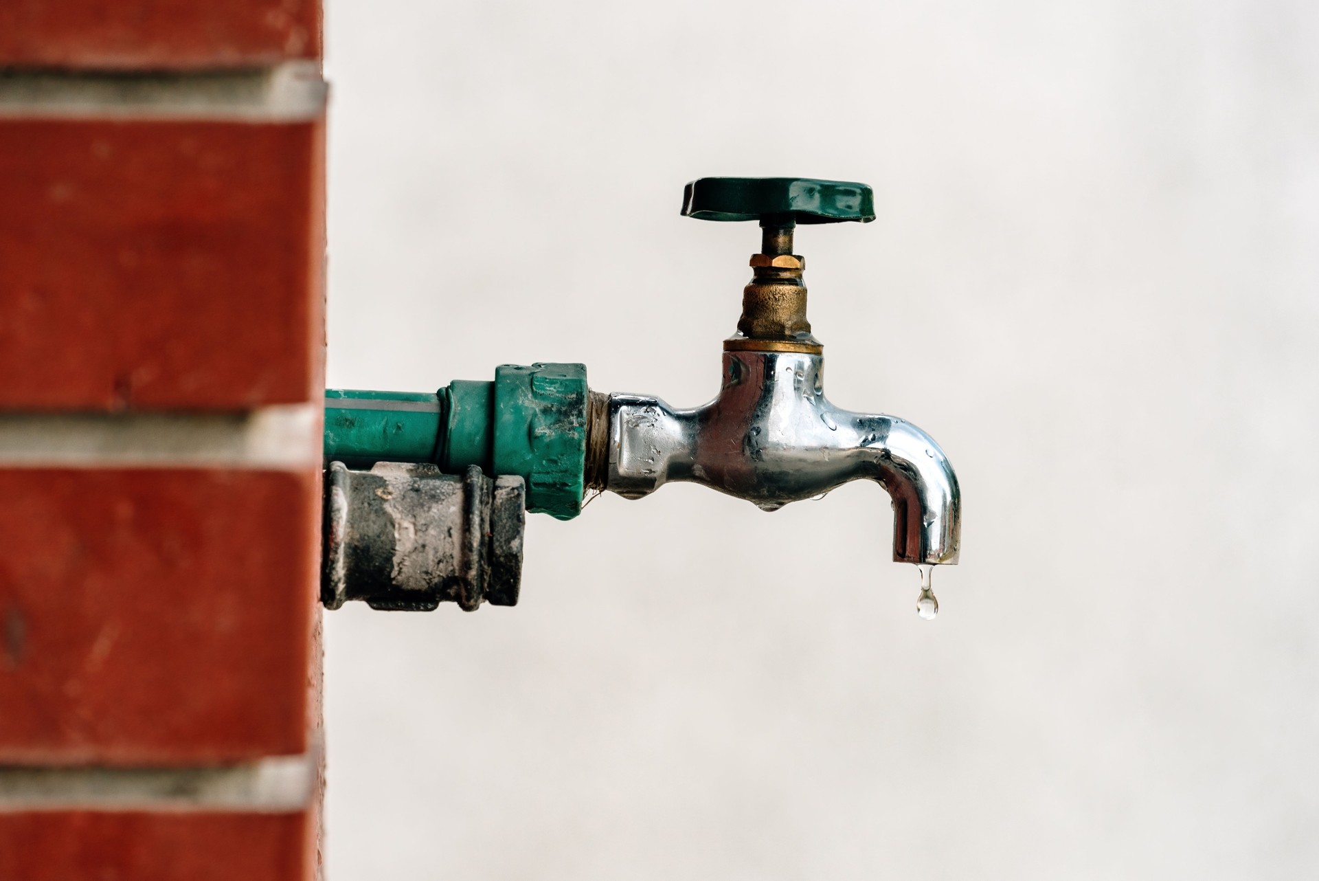 Back yard outdoor garden faucet with drop of water